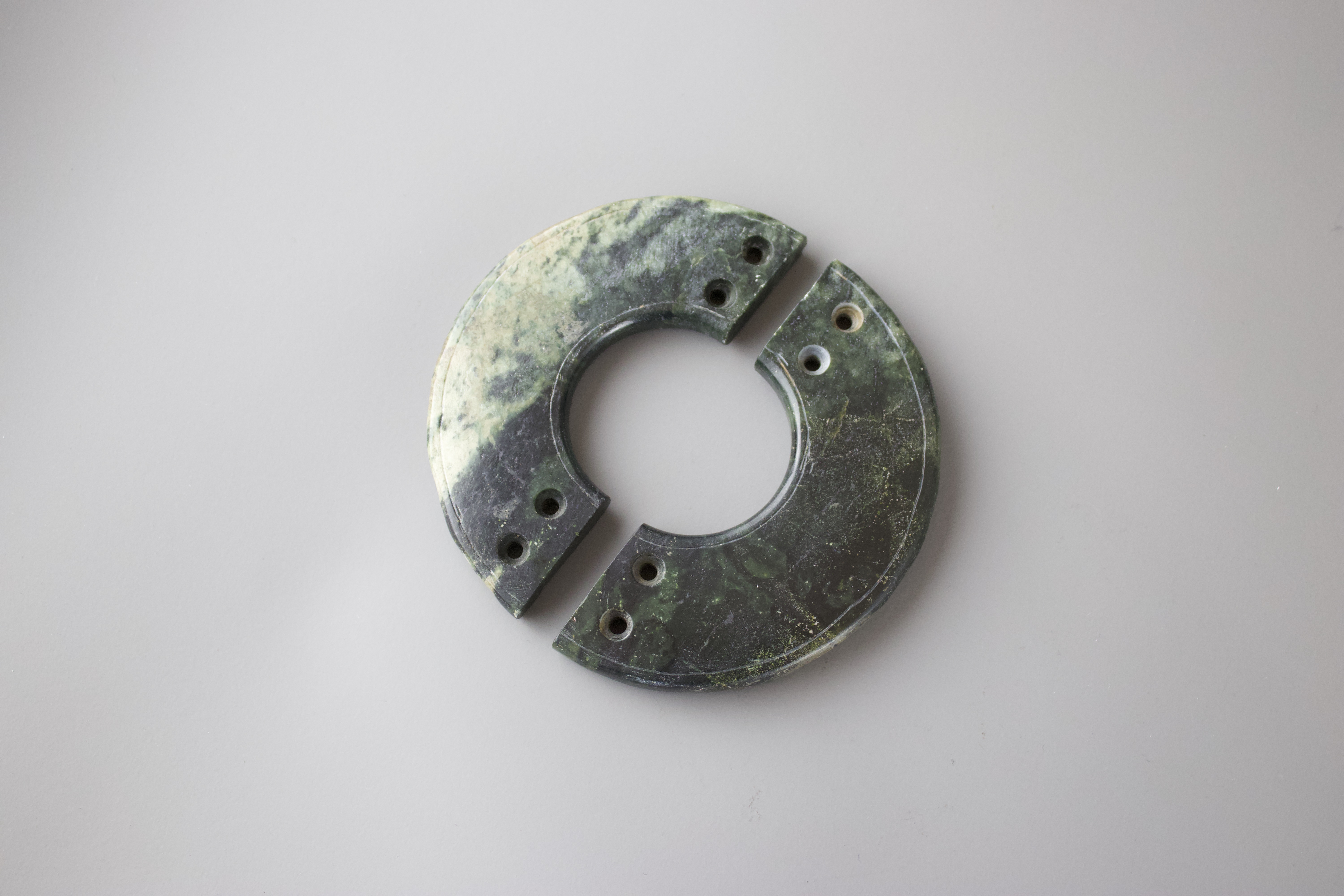 A Pair of Jade Huang, Neolithic or later each L: 10cm The two slim half discs carved from a dark