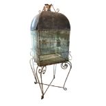 A LARGE 19TH CENTURY PAINTED IRON AND ZINC DOMED TOPPED BIRDCAGE ON WROUGHT IRON SCROLL WORK STAND.