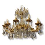 A LARGE EARLY 20TH CENTURY GILT BRONZE AND CRYSTAL HUNG TWELVE BRANCH CHANDELIER With acanthus and