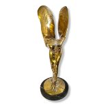 A 20TH CENTURY ORNAMENTAL POLISHED BRASS MODEL OF A STANDING SPIRIT OF ECSTASY Raised on a