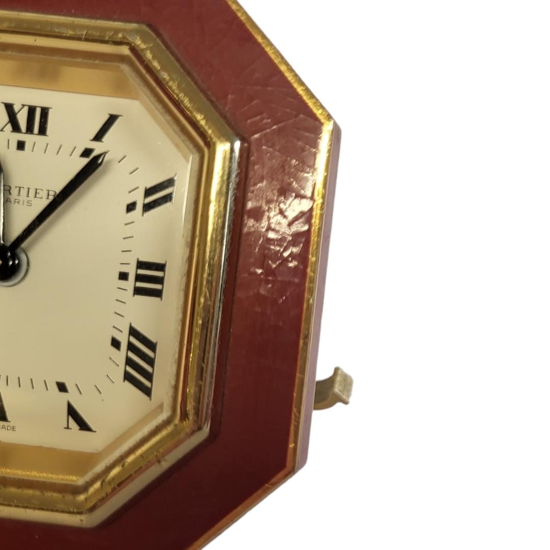 CARTIER, MUST DE CARTIER, A VINTAGE GILT METAL AND ENAMEL TRAVEL CLOCK Octagonal form with red - Image 5 of 14