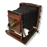 HOUGHTON VICTO HALF PLATE WOODEN BELLOWS CAMERA with Ensign/TTH Cooke Lens c.1893, dink in lens rim,