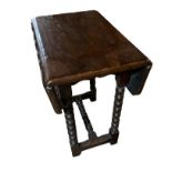 AN ANTIQUE OAK DROP LEAF OCCASIONAL TABLE On bobbin turned supports. (55cm x 32cm x 62cm) Condition: