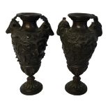 A PAIR OF 19TH CENTURY BRONZE FIGURAL VASES Classical urn form with two rams heads and cast