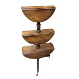 A VICTORIAN MAHOGANY DUMB WAITER With three graduating drop leaf tiers supported on a turned