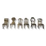 A COLLECTION OF WHITE METAL NOVELTY MINIATURE CHAIRS Including balloon back and Gothic design. (