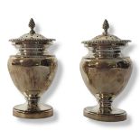 A PAIR OF VICTORIAN SILVER PEPPERETTES Classical urn form with gadrooned finial and border,