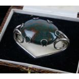 A VINTAGE WHITE METAL AND HARDSTONE SCARF CLIP The oval cabochon cut stone in a white metal mount,