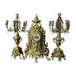 A LARGE MID 20TH CENTURY POLISHED BRASS CHIMING CLOCK AND GARNITURE FIVE BRANCH CANDELABRA. (h 60cm)