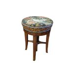 A LATE VICTORIAN MAHOGANY REVOLVING PIANO STOOL With floral upholstered seat, square swept legs. (