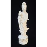 AN EARLY 20TH CENTURY CHINESE DEHUA BLANC DE CHINE FIGURE OF GUANYIN In long flowing lace robes,