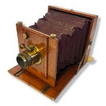 UNDERWOOD TOUROGRAPH HALF PLATE WOODEN BELLOWS CAMERA. Burgundy bellows with square corners,