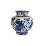 A CHINESE BLUE AND WHITE VASE The flared neck on a bulbous body, decorated with dragons and foliage,