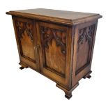 A LATE VICTORIAN GOTHIC REVIVAL MAHOGANY CASED GENTLEMAN’S TABLE CABINET SECRETAIRE With central