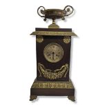 A LATE 19TH CENTURY FRENCH EMPIRE STYLE BRONZE AND ORMOLU MANTEL CLOCK Silvered dial, Roman