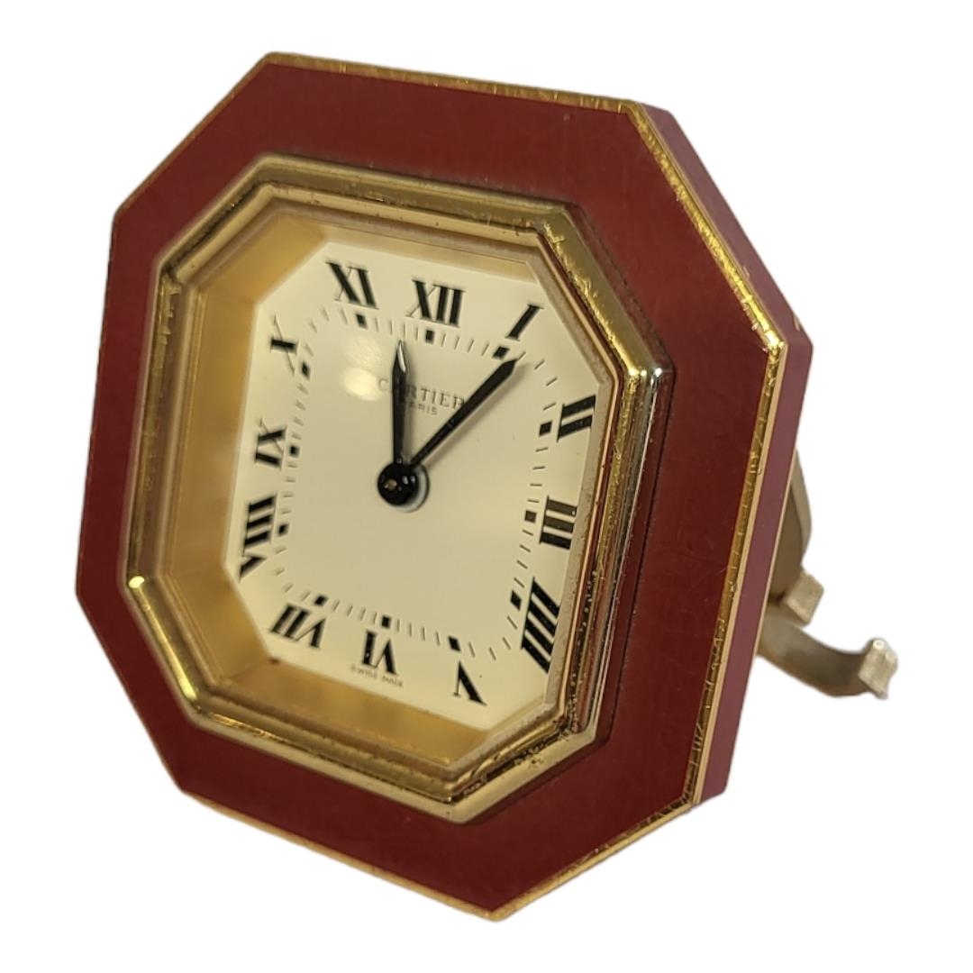 CARTIER, MUST DE CARTIER, A VINTAGE GILT METAL AND ENAMEL TRAVEL CLOCK Octagonal form with red - Image 3 of 14