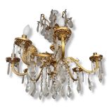 AN EARLY 20TH CENTURY GILT BRONZE AND CRYSTAL HUNG EIGHT BRANCH CHANDELIER With acanthus and faux