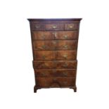 AN 18TH CENTURY FIGURED WALNUT TALLBOY CHEST With deep cushion cornice above three short and six