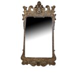 A GEORGE I STYLE SILVERED FRAMED MIRROR With shell and scroll decoration. (51cm x 96cm)