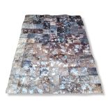A TAPIS CUIR FAUX HIDE AND SILVERED PATCHWORK RUG. (195 x 139cm) Condition: good overall