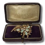 A VINTAGE YELLOW METAL OPAL AND SEED PEARL BROOCH The arrangement of oval cabochon cut stones