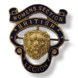 AN EARLY 20TH CENTURY 9CT GOLD AND ENAMEL BRITISH LEGION BADGE A central lion mask in a pierced