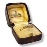 AN EARLY 20TH CENTURY 18CT GOLD AND DIAMOND FIVE STONE RING Having a row of graduated round cut