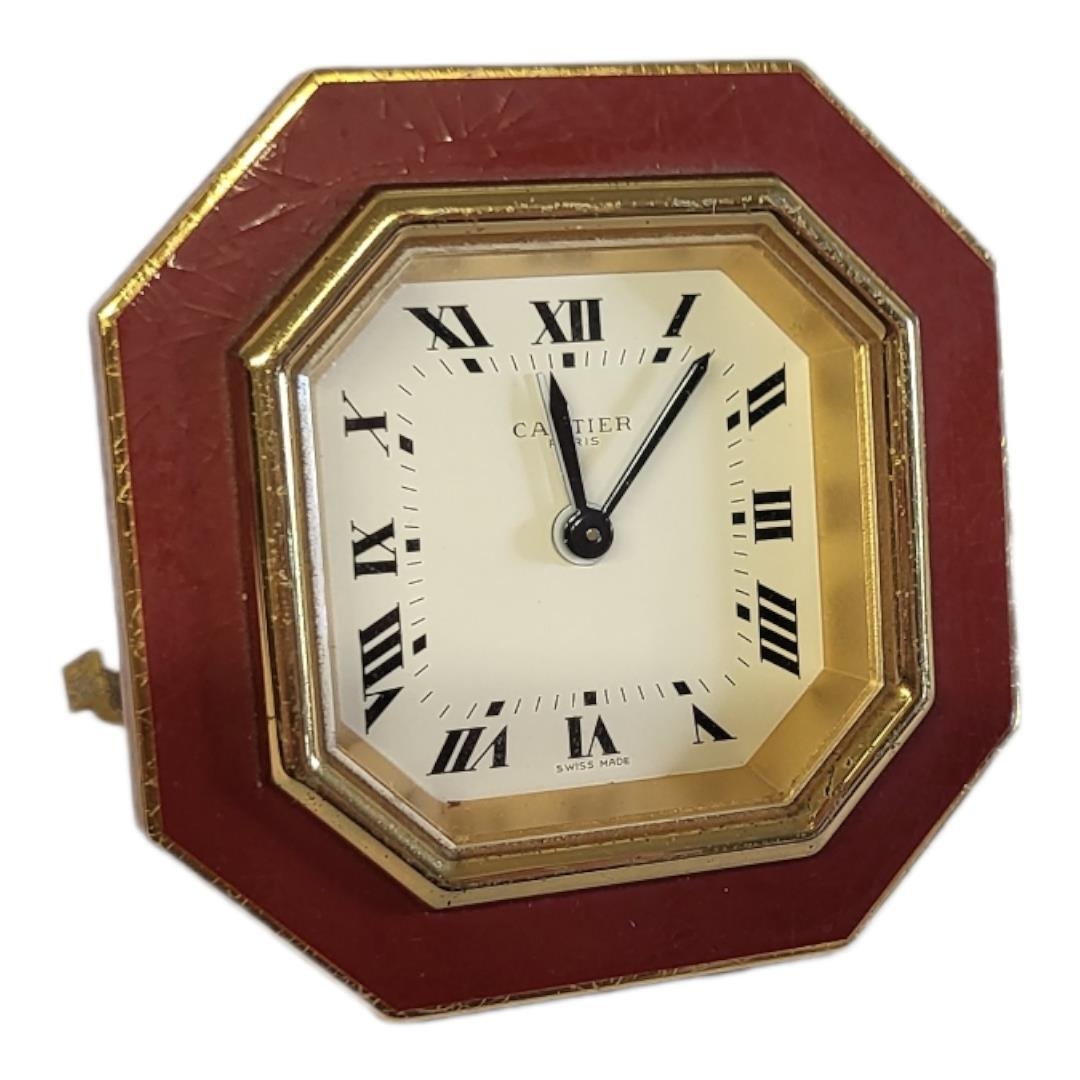 CARTIER, MUST DE CARTIER, A VINTAGE GILT METAL AND ENAMEL TRAVEL CLOCK Octagonal form with red - Image 8 of 14
