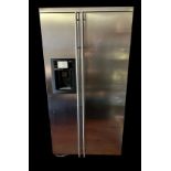 A GENERAL ELECTRIC STAINLESS STEEL SIDE BY SIDE REFRIGERATOR. (90cm x 68cm x 180cm) Condition: good,