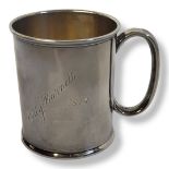 AN EARLY 20TH CENTURY SILVER CHRISTENING MUG Having a single carry handle and engraved