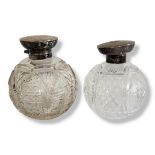 TWO LARGE SPHERICAL EARLY 20TH CENTURY CUT GLASS SILVER TOPPED SCENT BOTTLES With stoppers,