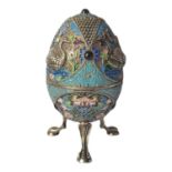 A RUSSIAN SILVER AND CLOISONNÉ ENAMEL DOMED EGG With cabochon cut stones, embossed swans and