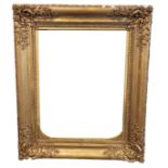 A LARGE 19TH CENTURY GILT A GESSO PICTURE/MIRROR FRAME. (107cm x 128cm) Condition: some losses in