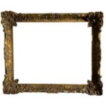 A 19TH CENTURY GILT AND GESSO SWEPT FRAME Decorated with shells scrolling foliage, berries and