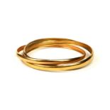 A FRENCH 18CT TRICOLOURED GOLD TRINITY BANGLE. (diameter 69mm, 17.9g)