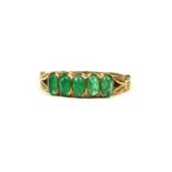 A 9CT GOLD AND FIVE STONE NEPHRITE RING. (size S)
