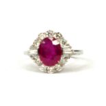 18CT WHITE GOLD OVAL RUBY AND DIAMOND CLUSTER RING. (Approx. Ruby 2.05ct. Diamonds 0.85ct)