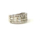 A 9CT WHITE GOLD DIAMOND BAND set with baguette cut and round brilliant cut diamonds. (Approx