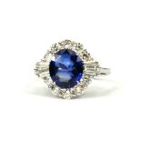 AN 18CT WHITE GOLD OVAL SAPPHIRE AND DIAMOND CLUSTER RING with WGI Certificate (Sapphire 2.83ct.