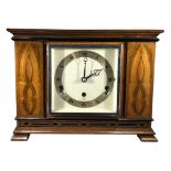 ELLIOT, LONDON, AN ART DECO 8-DAY LEVER WESTMINSTER WALNUT AND EBONISED MANTLE CLOCK Having a