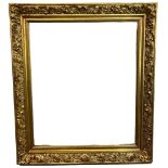 A 19TH CENTURY GILT AND GESSO FRAME Decorated with scrolling foliage and flowerheads. (59cm x