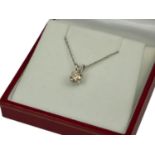 AN 18CT WHITE GOLD SOLITAIRE DIAMOND PENDANT ON A SILVER CHAIN. (Approx Diamond 0.74ct)