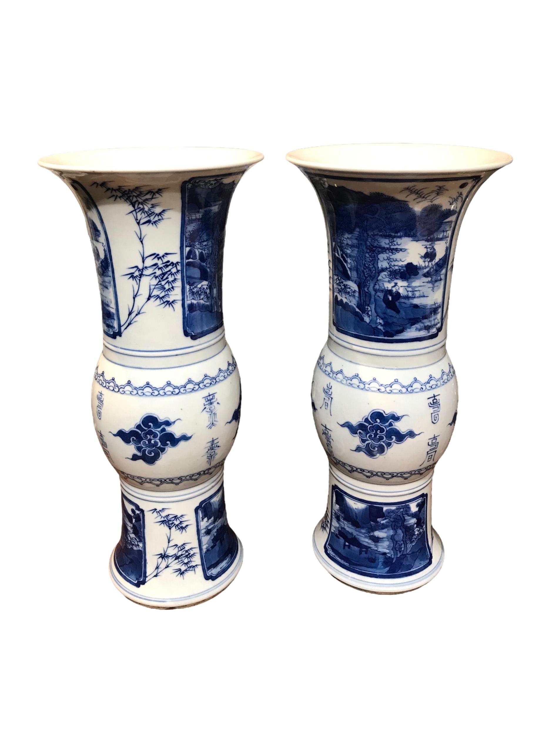 A PAIR OF CHINESE BLUE AND WHITE GU BEAKER FORM VASES Decorated with calligraphy in between