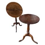 TWO 18TH CENTURY OAK CIRCULAR OCCASIONAL TRIPOD TABLES Supported on turned columns, raised on