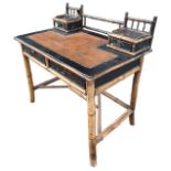 A 19TH CENTURY AESTHETIC MOVEMENT ANGLO-JAPANESE BAMBOO LEATHER TOP WRITING TABLE With gallery