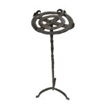A 16TH/17TH CENTURY WROUGHT IRON CANDLE STAND Raised on candy twist supports and terminating on a