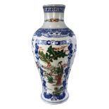 A CHINESE FAMILLE VERTE VASE ON WHITE GROUND Figural scenes within blue floral panels, bearing