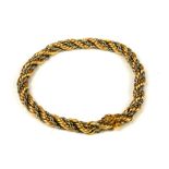 AN ITALIAN 18CT YELLOW AND WHITE GOLD ROPE TWIST BRACELET. (length 20.5cm, 16.7g)