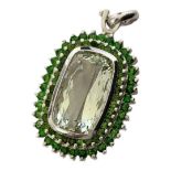 A LARGE SILVER AND GREEN PRESULITE QUARTZ PENDANT The rectangular faceted central stone with round