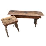 AN 18TH CENTURY ITALIAN WALNUT BENCH AND STOOL The single plank raised on shaped supports. (bench